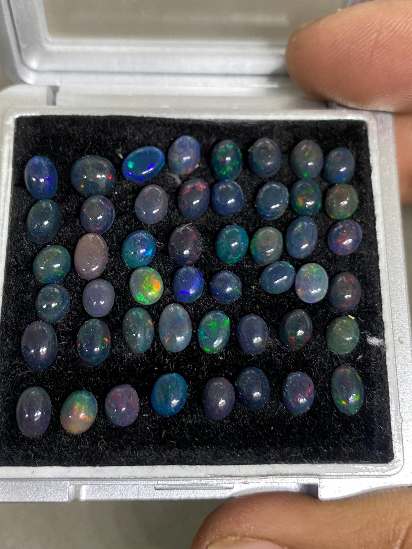 Dazzling Black Natural opal (smoked) Ethiopian mines opal cabochons lot size 4mm-5mm wt 11.85 cts pcs 48 black opal cabochons (torch light)