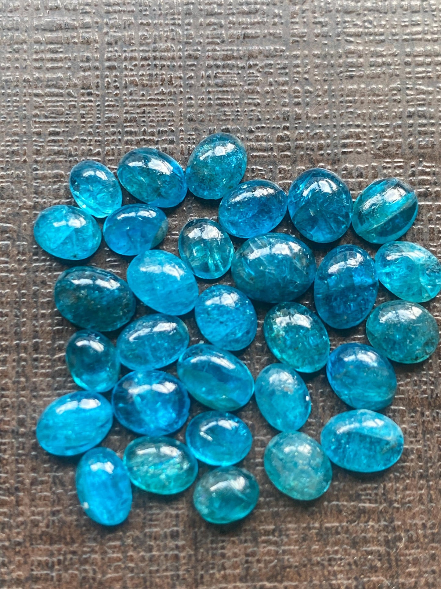 Neon blue apatite flat cabochons oval rounds wholesale lot pcs 30 weight 16.15 carats size 5x3.7mm-6.7x5.6mm electric blue apatite cabochons