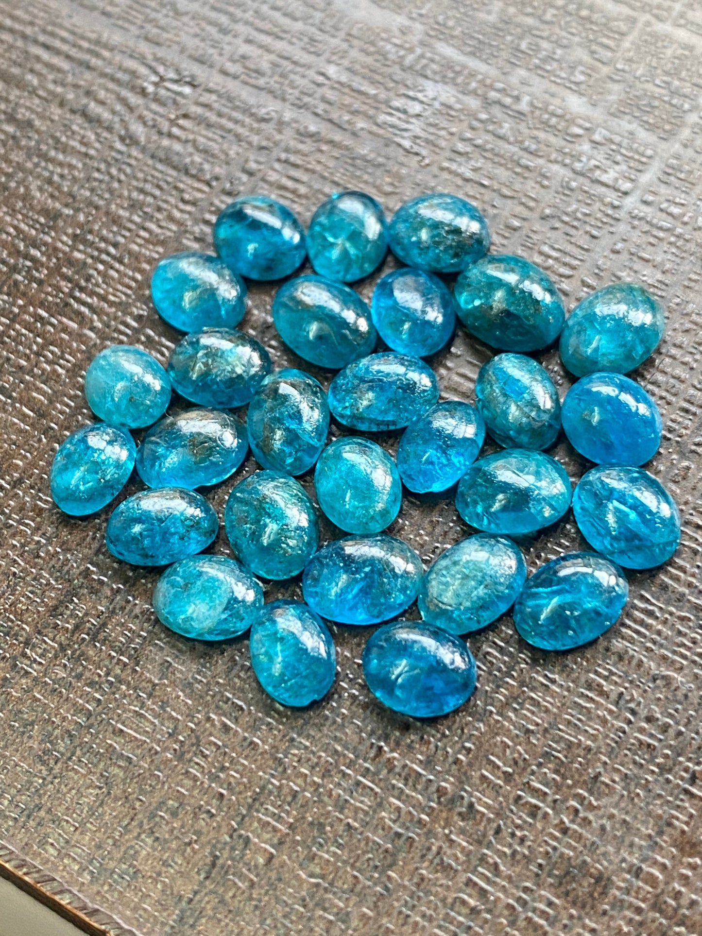 Neon blue apatite flat cabochons oval rounds wholesale lot pcs 28 weight 19.40 carats size 6x4.8mm-6.4x4.5mm electric blue apatite cabochons