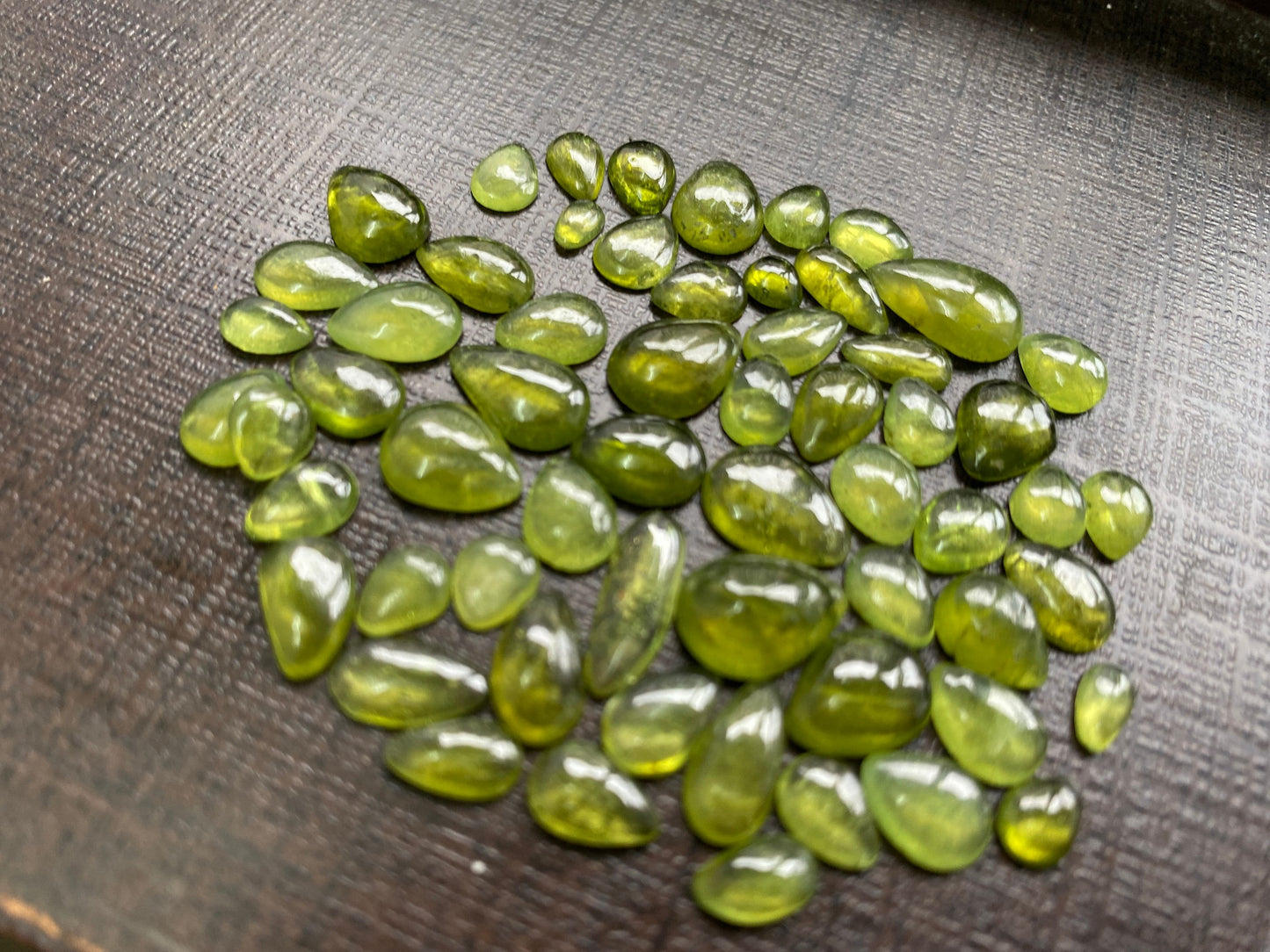 Beautiful fine quality peridot cabochons pear shape wholesale lot weight 65 carats size 5.5x3.5mm-13x8mm pieces 59 peridot cabochons