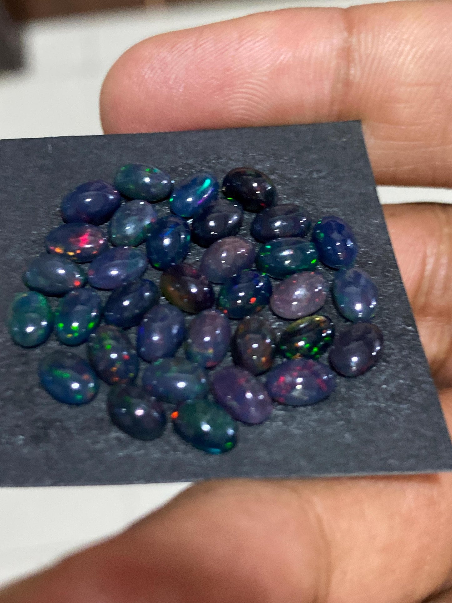 Black Natural opal (smoked) Ethiopian mines Natural opal cabochons lot size 6x4mm wt 11 carats pcs 34 black opal cabochons (torch light)