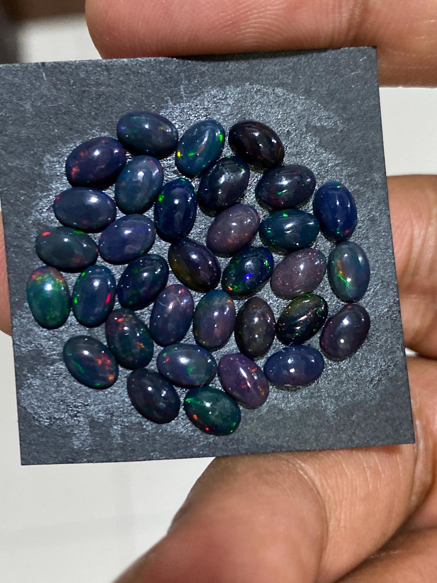 Black Natural opal (smoked) Ethiopian mines Natural opal cabochons lot size 6x4mm wt 11 carats pcs 34 black opal cabochons (torch light)