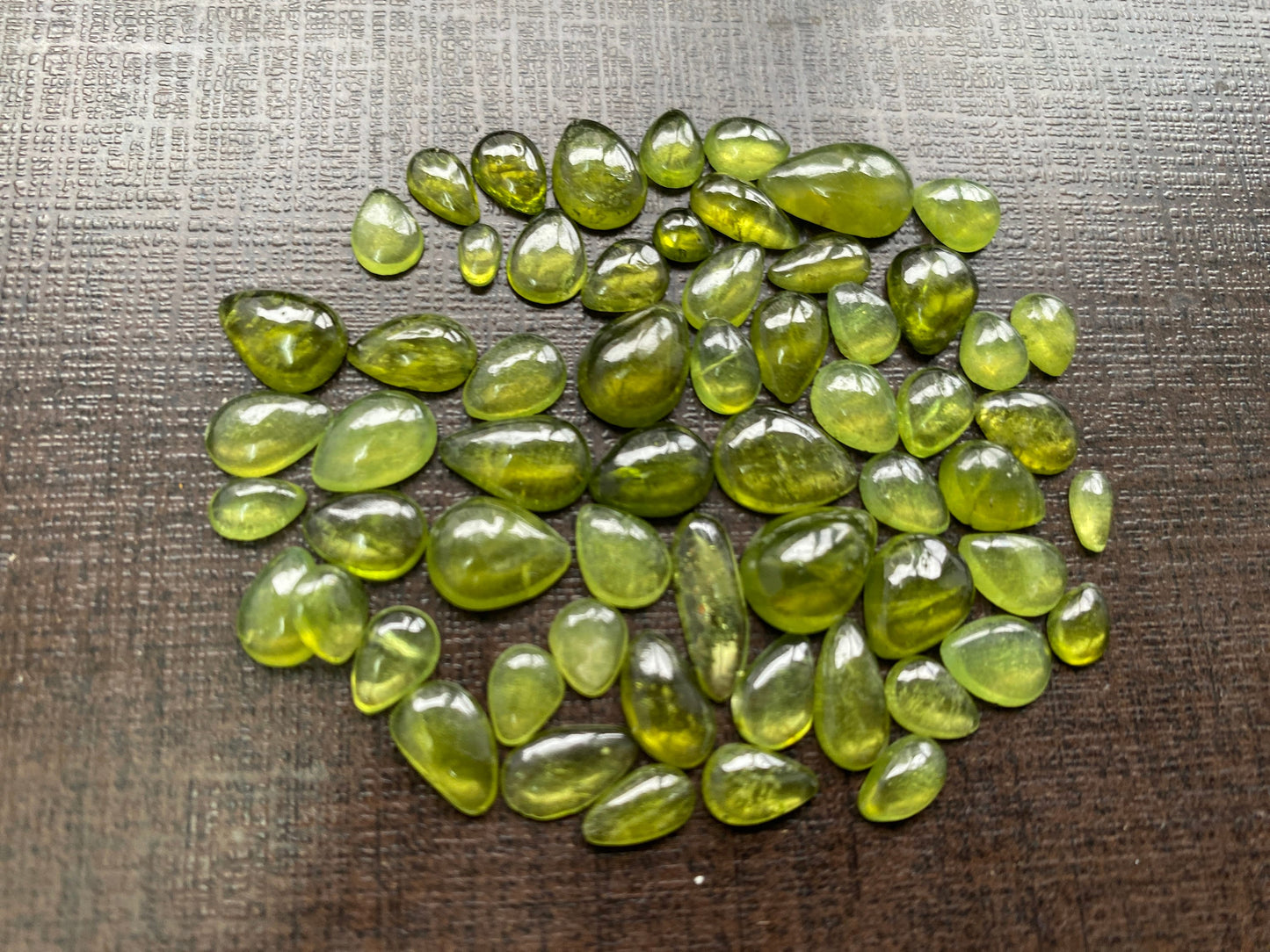 Beautiful fine quality peridot cabochons pear shape wholesale lot weight 65 carats size 5.5x3.5mm-13x8mm pieces 59 peridot cabochons