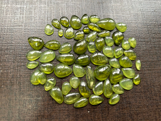 Beautiful fine quality peridot cabochons pear shape wholesale lot weight 65 carats size 5.5x3.5mm-13x8mm pieces 59 peridot cabochons