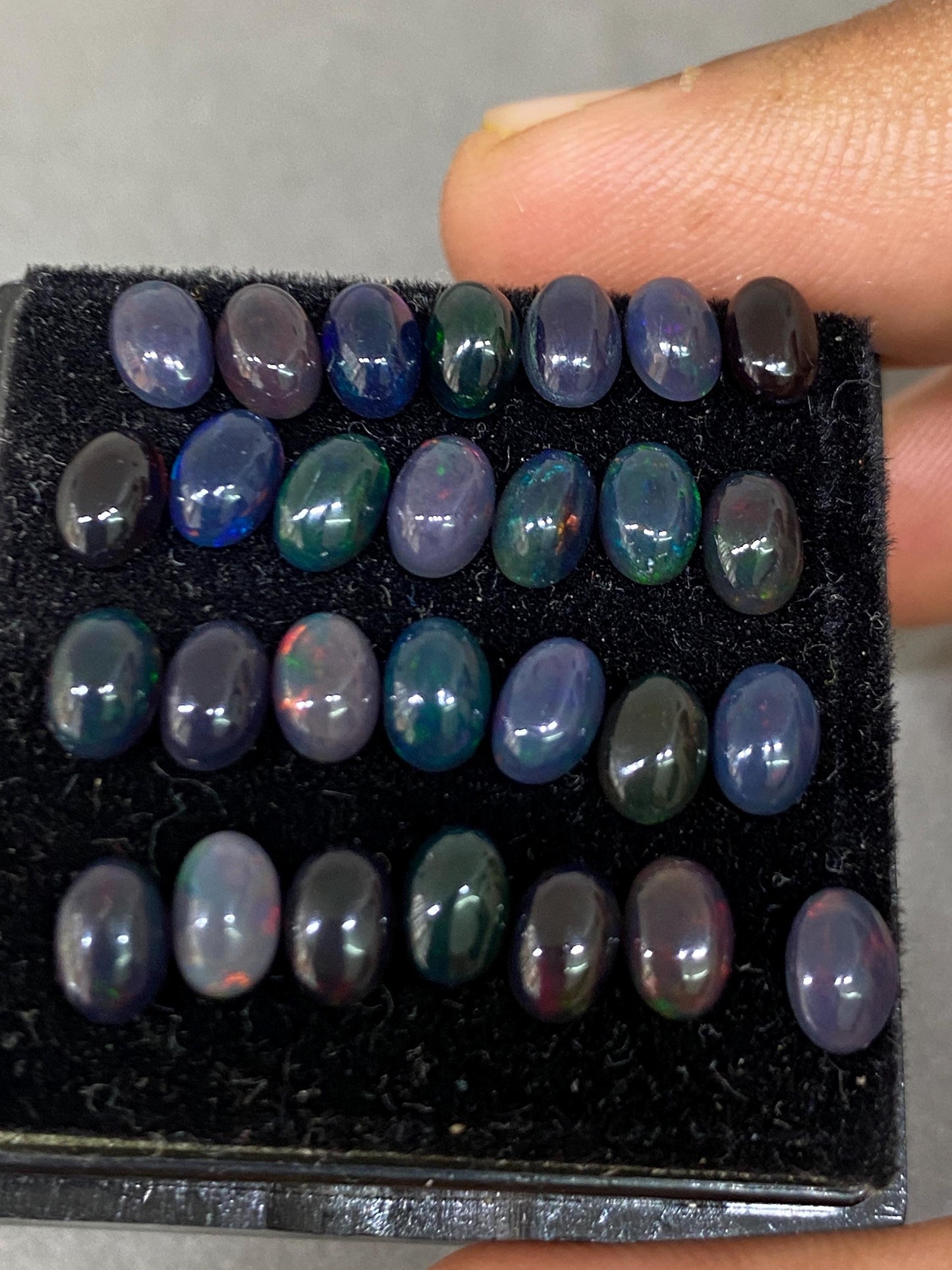 Vivacious Black Natural opal (smoked) Ethiopian mines opal cabochons lot size 6x4mm wt 9.20 cts pcs 28 black opal cabochons (torch light)