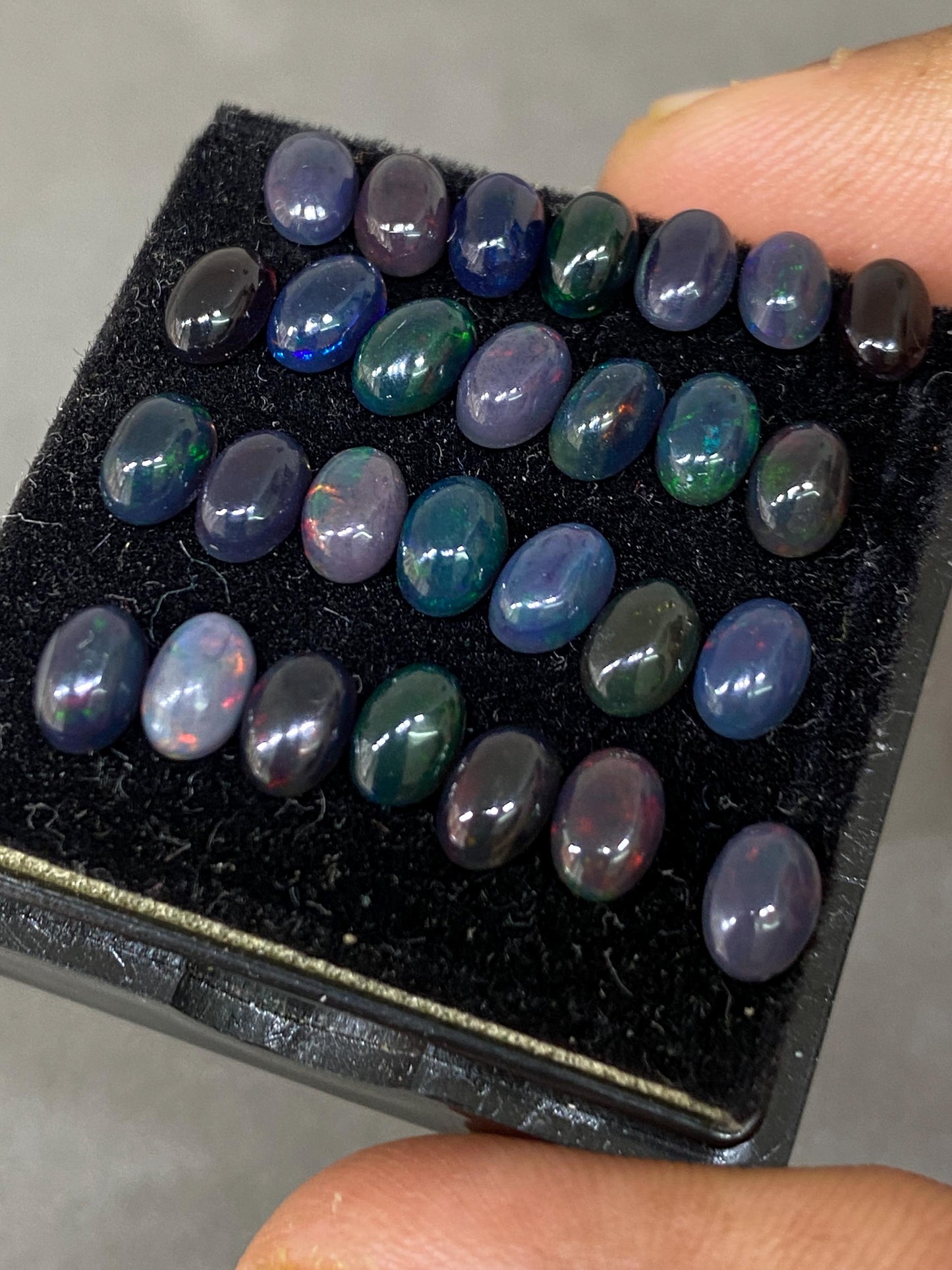 Vivacious Black Natural opal (smoked) Ethiopian mines opal cabochons lot size 6x4mm wt 9.20 cts pcs 28 black opal cabochons (torch light)