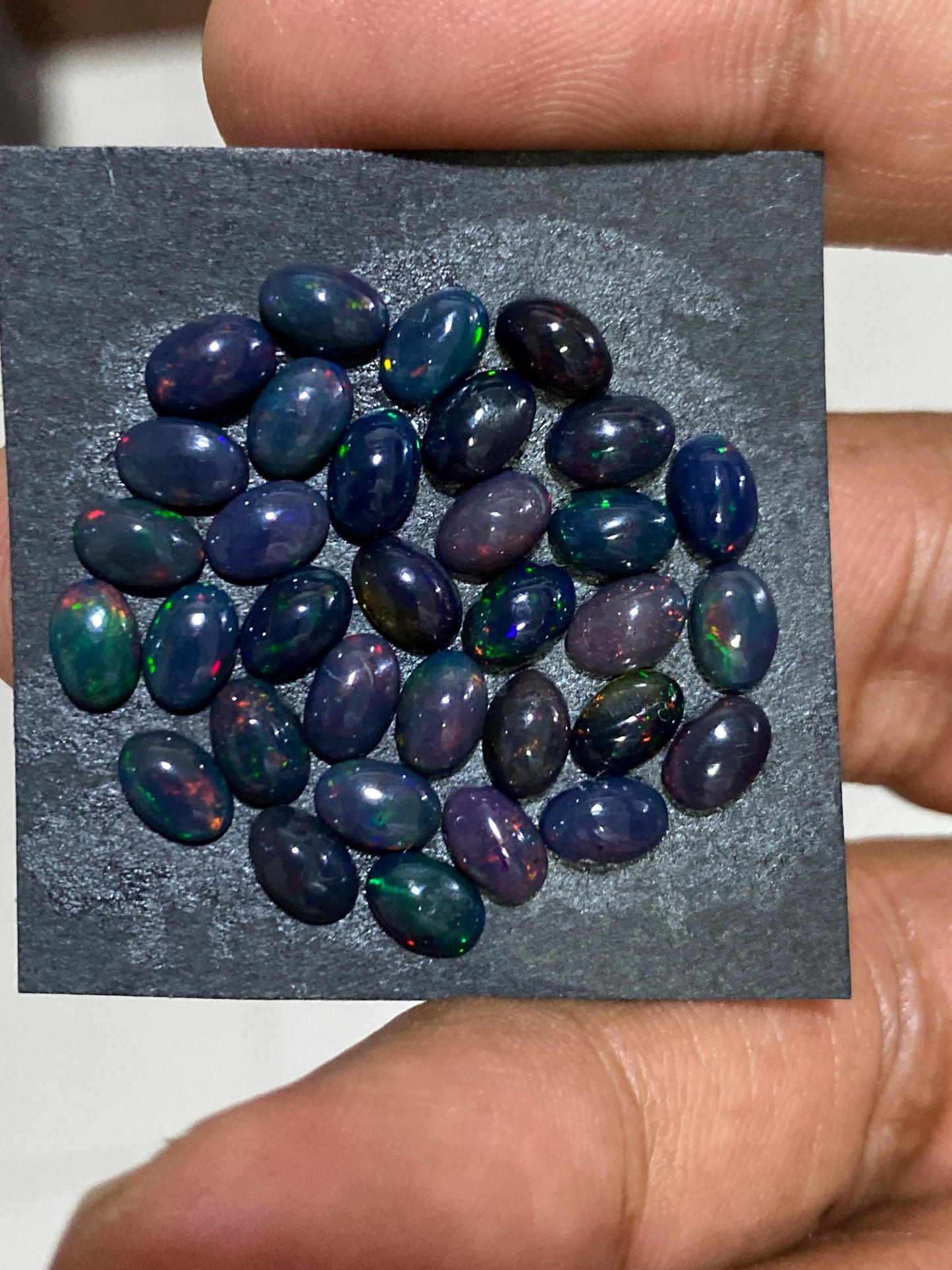 Black Natural opal (smoked) Ethiopian mines Natural opal cabochons lot size 6x4mm wt 11 carats pcs 34 black opal cabochons (torch light)