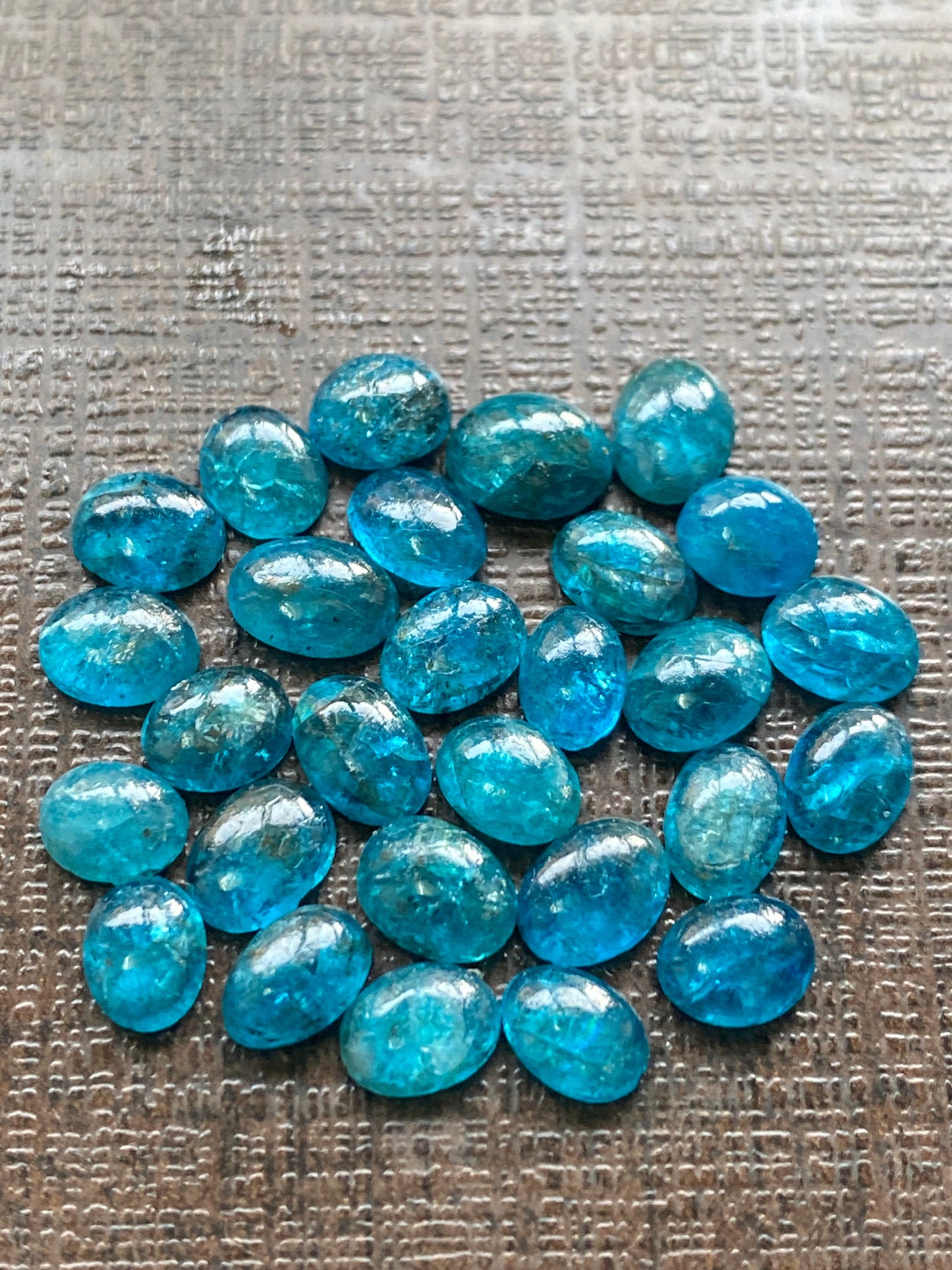 Neon blue apatite flat cabochons oval rounds wholesale lot pcs 28 weight 19.40 carats size 6x4.8mm-6.4x4.5mm electric blue apatite cabochons