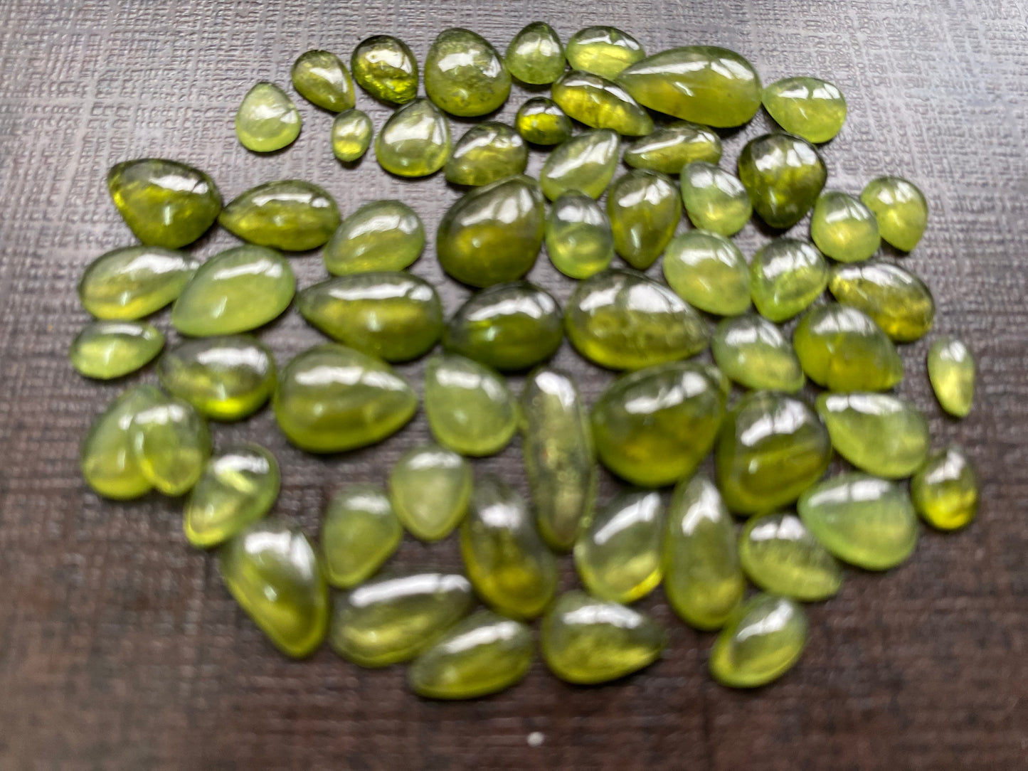 Beautiful fine quality peridot cabochons pear shape wholesale lot weight 65 carats size 5.5x3.5mm-13x8mm pieces 59 peridot cabochons