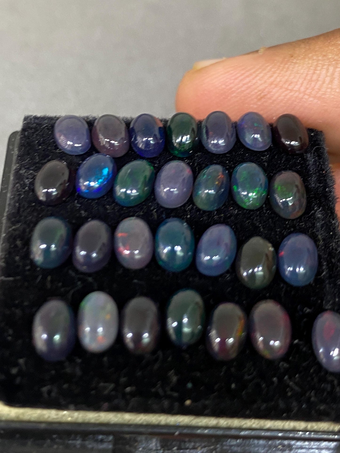 Vivacious Black Natural opal (smoked) Ethiopian mines opal cabochons lot size 6x4mm wt 9.20 cts pcs 28 black opal cabochons (torch light)