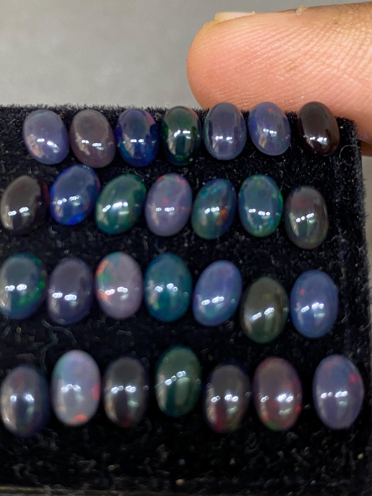 Vivacious Black Natural opal (smoked) Ethiopian mines opal cabochons lot size 6x4mm wt 9.20 cts pcs 28 black opal cabochons (torch light)