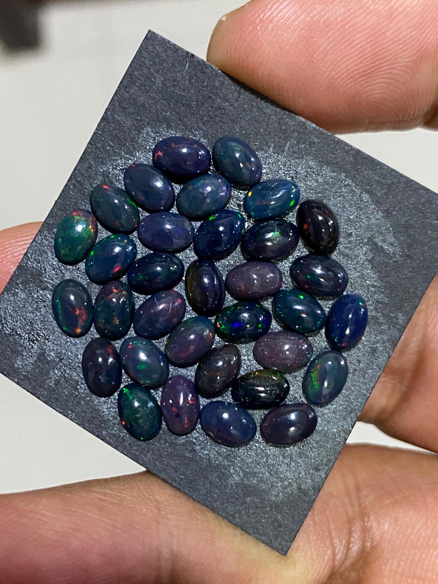 Black Natural opal (smoked) Ethiopian mines Natural opal cabochons lot size 6x4mm wt 11 carats pcs 34 black opal cabochons (torch light)