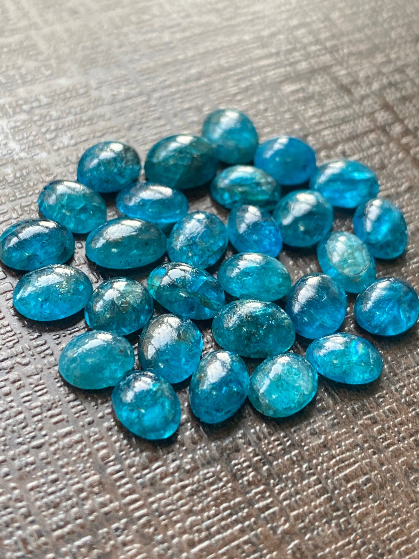 Neon blue apatite flat cabochons oval rounds wholesale lot pcs 28 weight 19.40 carats size 6x4.8mm-6.4x4.5mm electric blue apatite cabochons