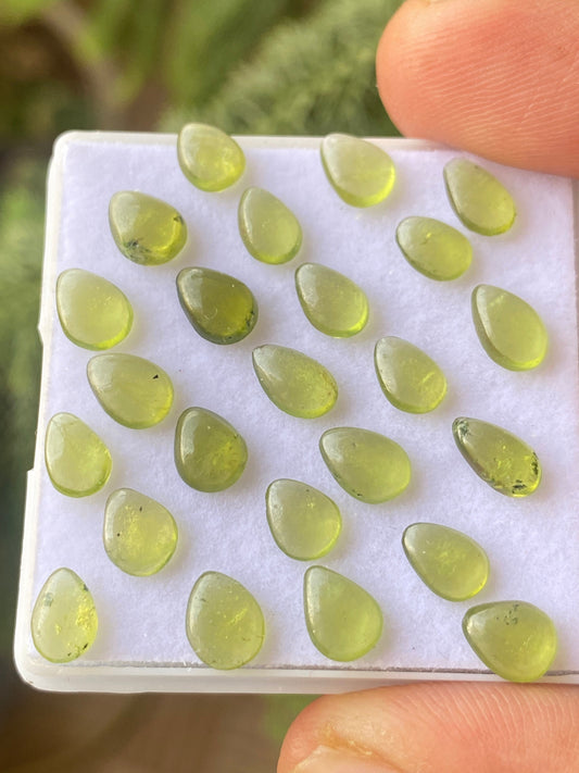 Dazzling fine quality peridot cabochons ovals wholesale lot weight 12.30 carats size 7x5mm pieces 24 peridot cabochons