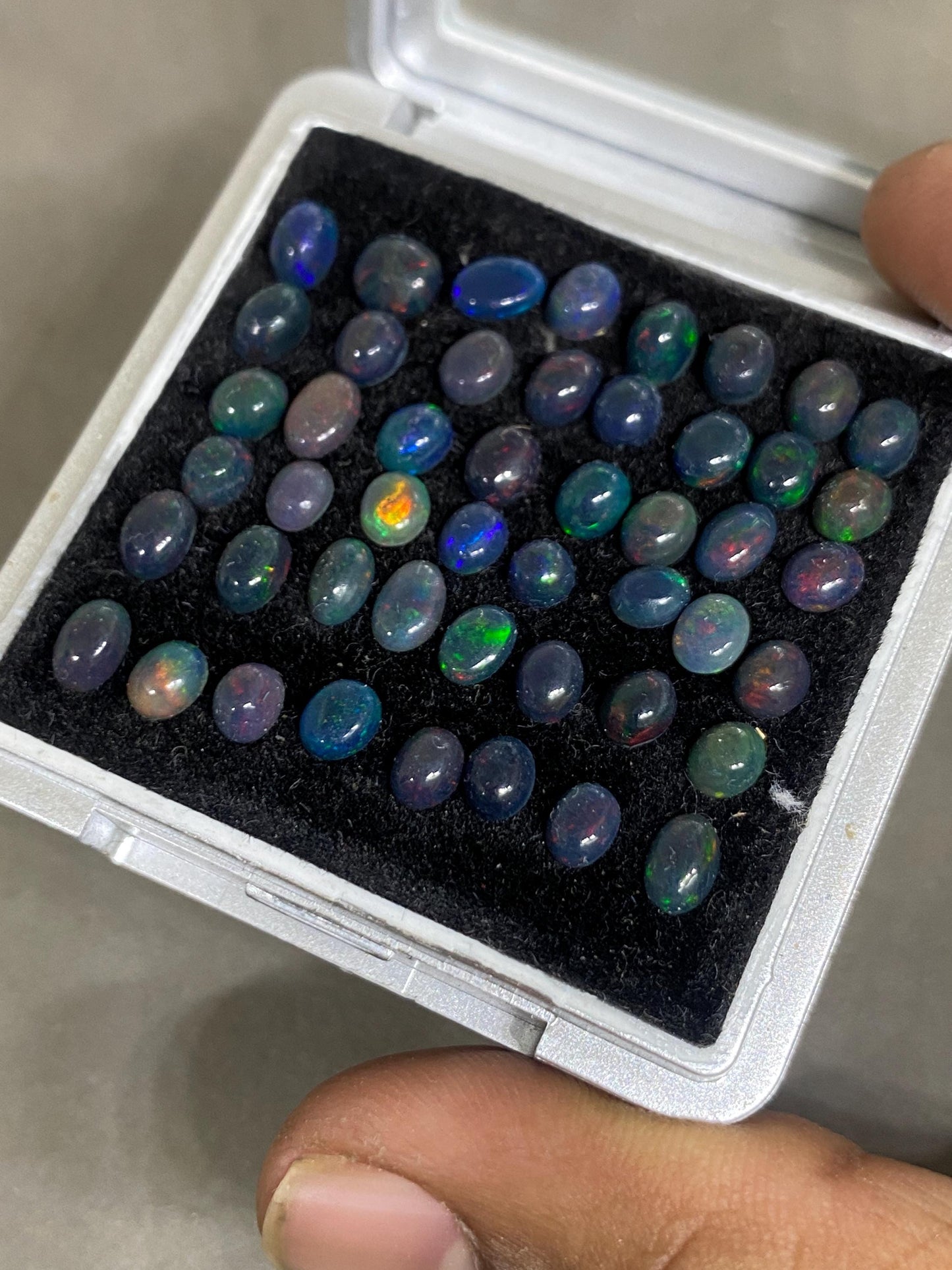 Dazzling Black Natural opal (smoked) Ethiopian mines opal cabochons lot size 4mm-5mm wt 11.85 cts pcs 48 black opal cabochons (torch light)