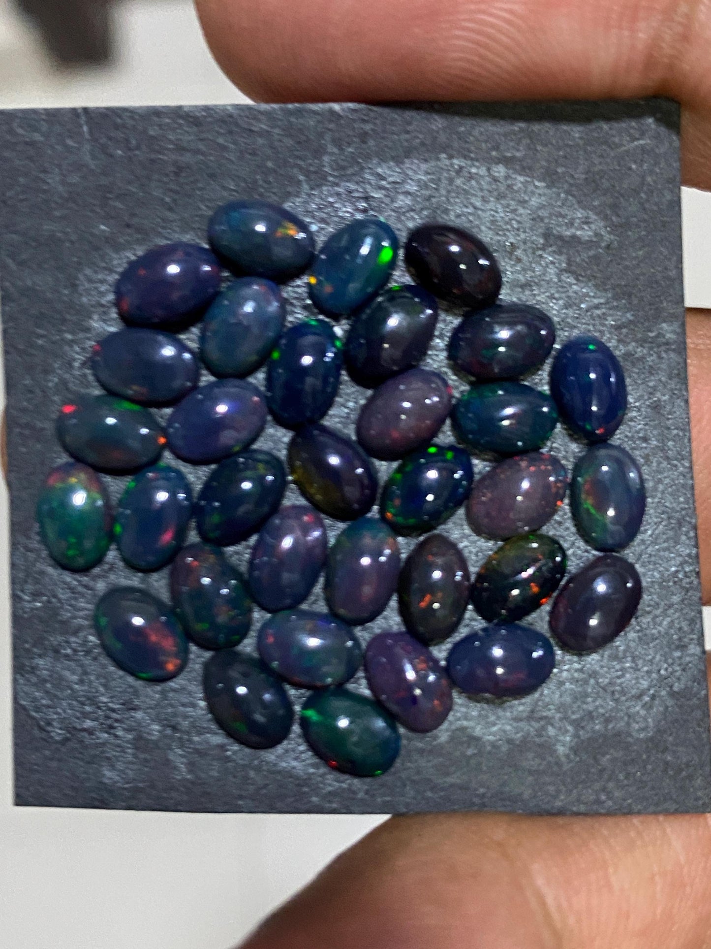 Black Natural opal (smoked) Ethiopian mines Natural opal cabochons lot size 6x4mm wt 11 carats pcs 34 black opal cabochons (torch light)