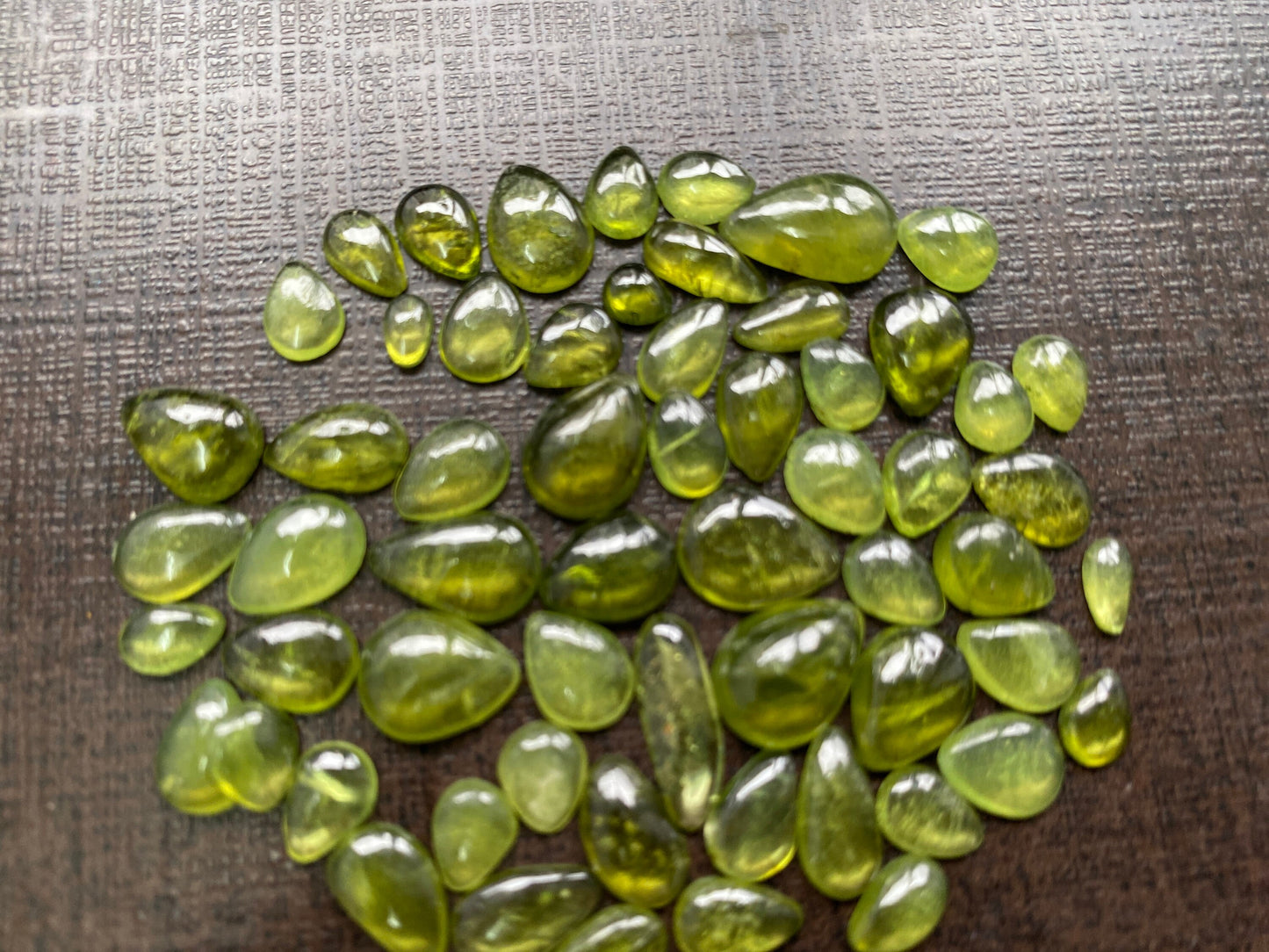 Beautiful fine quality peridot cabochons pear shape wholesale lot weight 65 carats size 5.5x3.5mm-13x8mm pieces 59 peridot cabochons