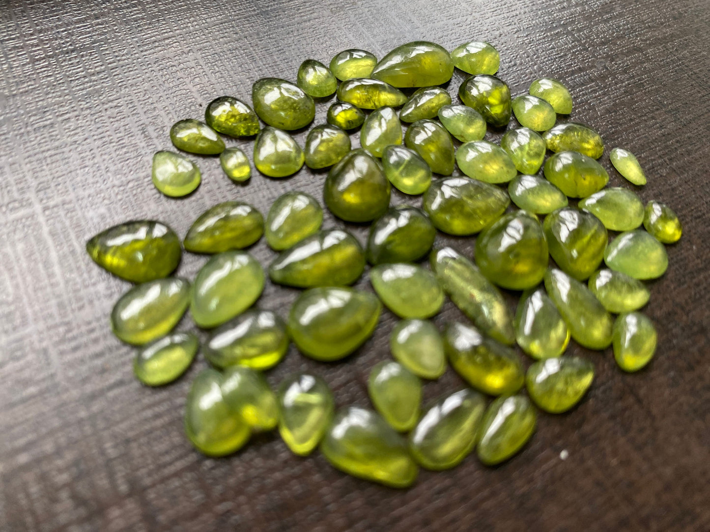 Beautiful fine quality peridot cabochons pear shape wholesale lot weight 65 carats size 5.5x3.5mm-13x8mm pieces 59 peridot cabochons