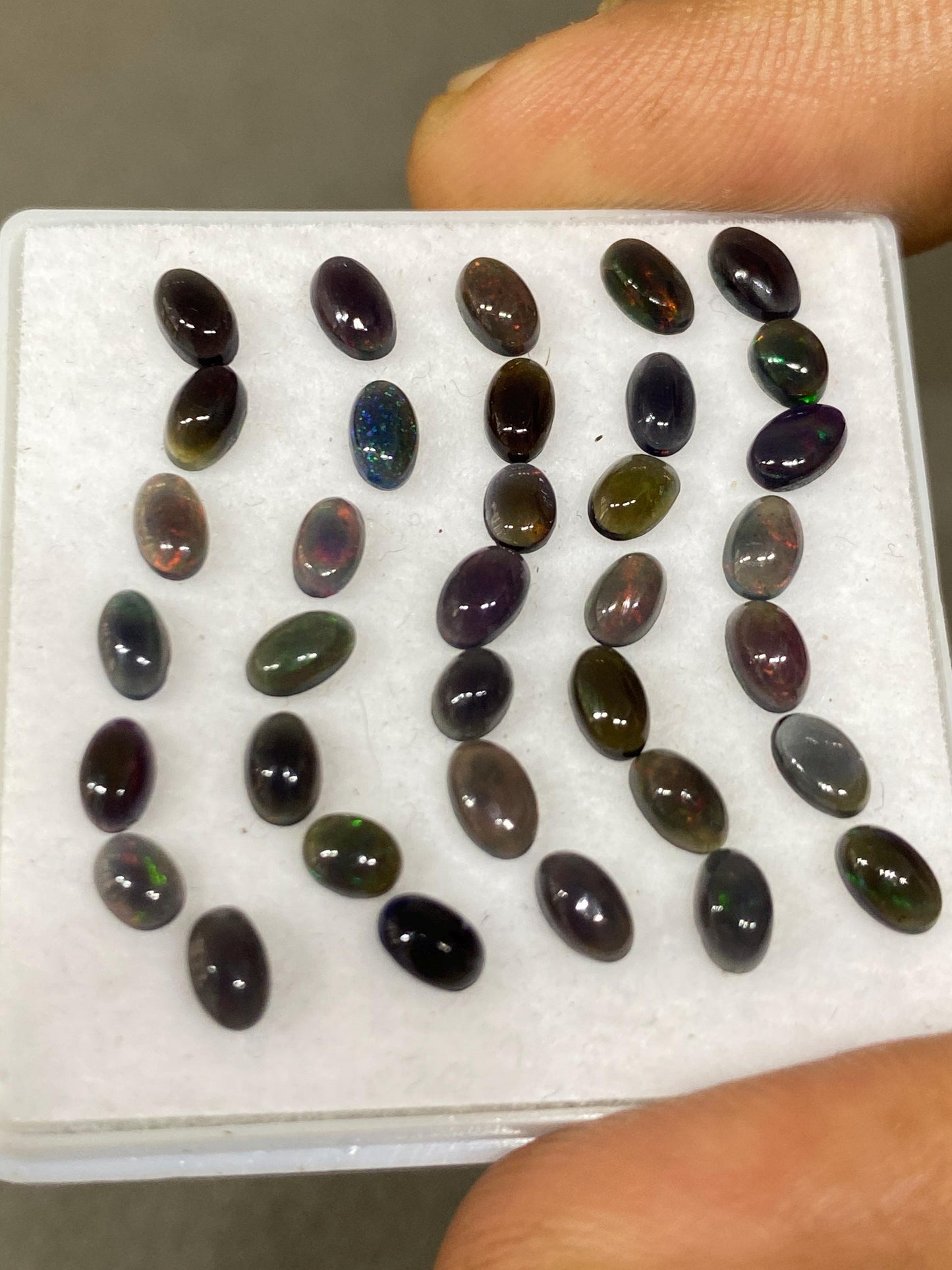 Black Natural opal (smoked) Ethiopian mines Natural opal cabochons lot size 5x3mm wt 5.75 carats pcs 35 black opal cabochons (torch light)