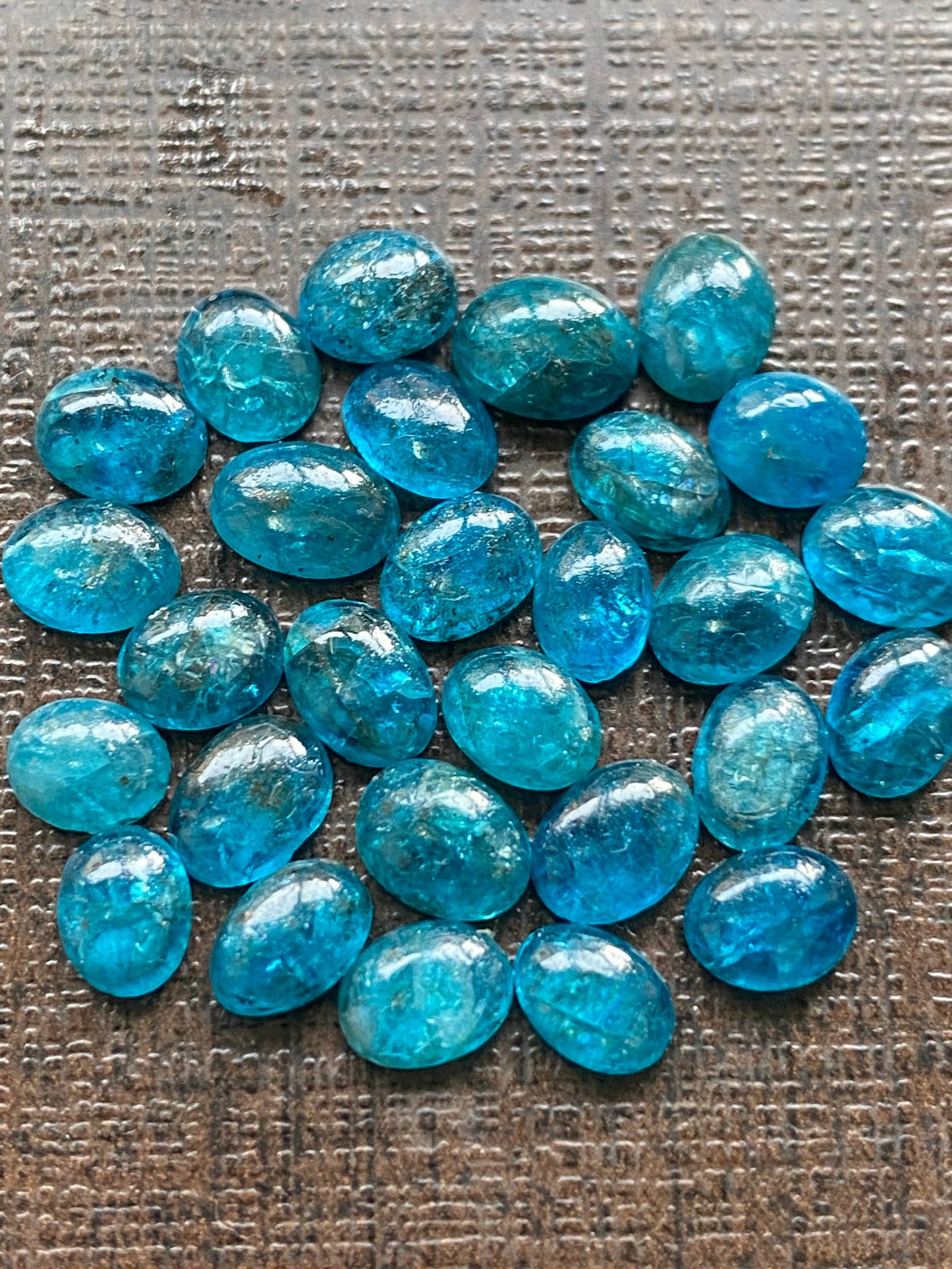 Neon blue apatite flat cabochons oval rounds wholesale lot pcs 28 weight 19.40 carats size 6x4.8mm-6.4x4.5mm electric blue apatite cabochons